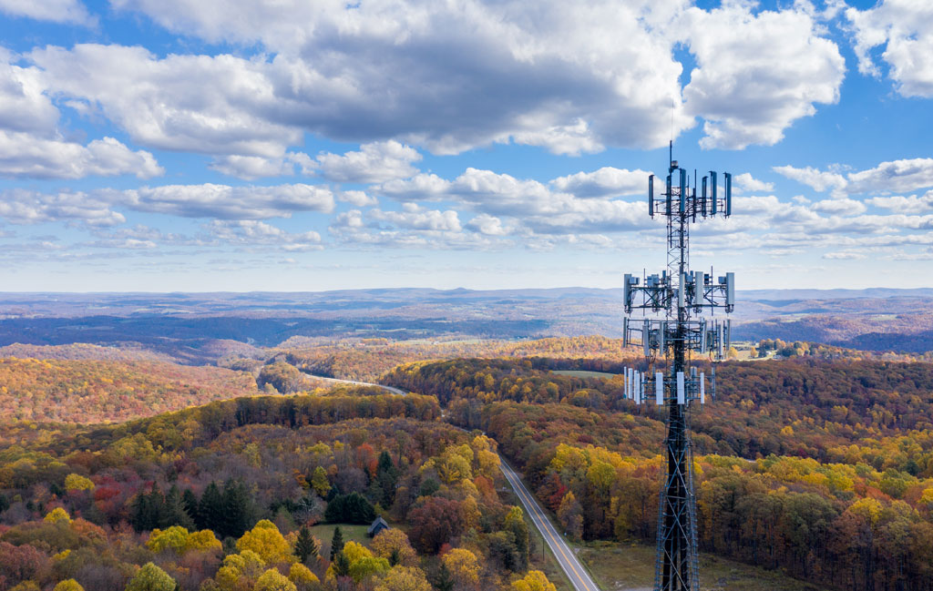 Aerial view of a mobile service tower in forested area of West Virginia.