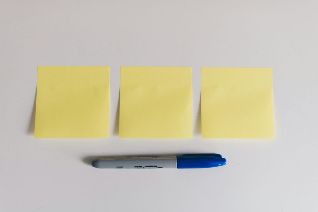 Post-it notes and a blue pen